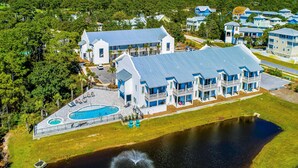 A large resort with multiple buildings, a swimming pool, and a lake. - Azure on 30A 1-205- A Wave From it All (Santa Rosa Beach)