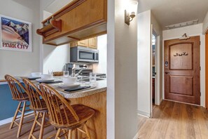 The small but well-equipped kitchen with a breakfast bar. - 1 Block to PCMR - Condo with Hot Tub | Managed by Park City Lodging (Park City)