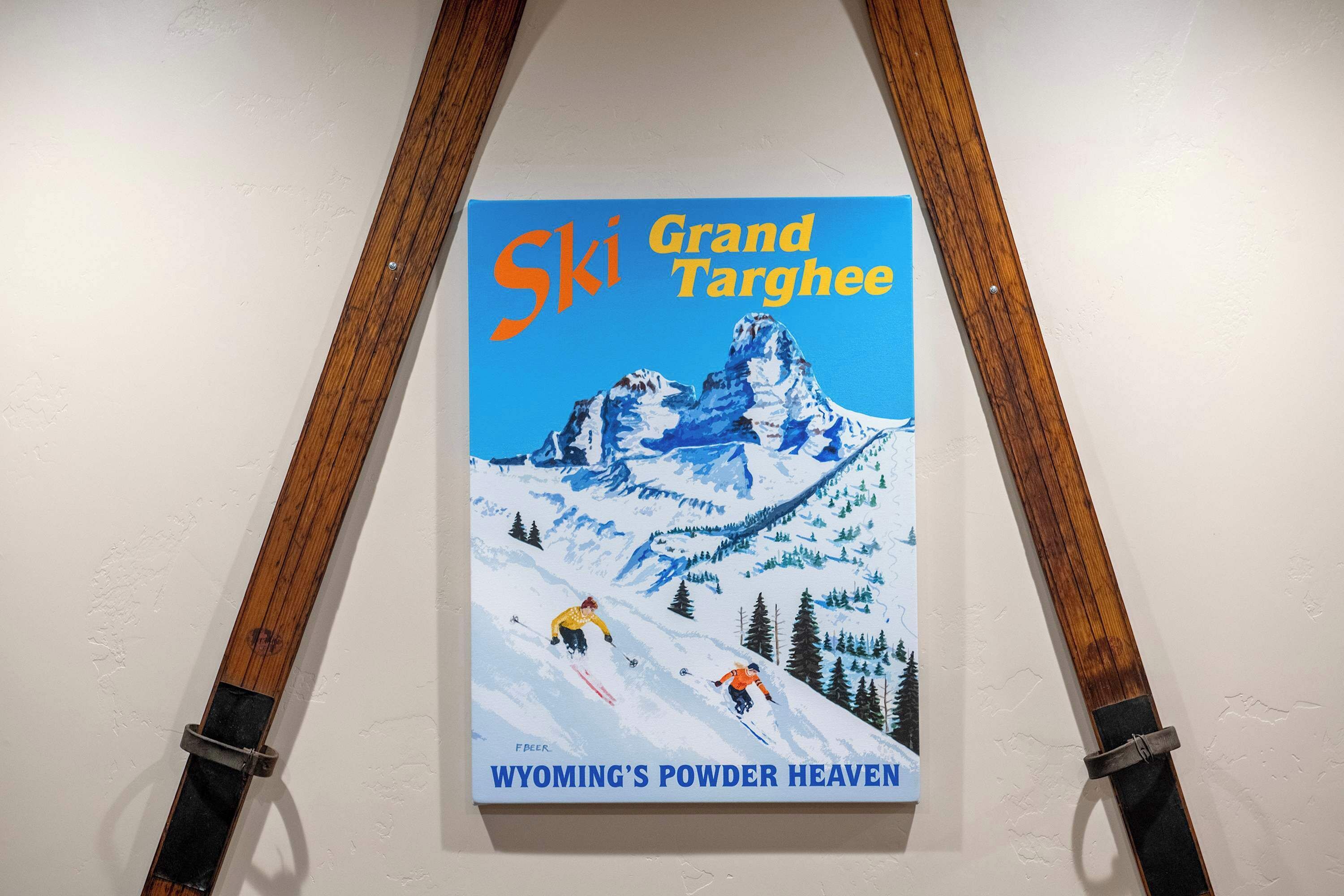 A poster of 'Ski Grand Targhee' with skiers on a snowy mountain.