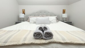 A neatly made bed with a striped blanket, two bedside lamps, and a headboard. - Charming Conshohocken B&B Near Philly (Conshohocken)