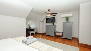 A bedroom with a bed, a desk, a chair, a wardrobe, and a ceiling fan. - Charming Conshohocken B&B Near Philly (Conshohocken)