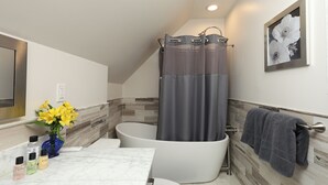 A modern bathroom with a freestanding bathtub, a marble countertop, and a wall-mounted towel rack. - Boutique Conshohocken (near Philadelphia) King & Queen Suite - Breakfast Included (Conshohocken)