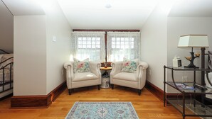A cozy living room with a sofa set, a small table with a lamp, and a glass coffee table. - Boutique Conshohocken (near Philadelphia) King & Queen Suite - Breakfast Included (Conshohocken)
