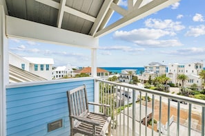 A balcony with a view of a coastal town and the ocean. - Rooftop Gulf Views & Private Pool (Santa Rosa Beach)