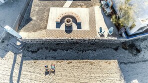 An aerial view of a beach area with a fire pit, two beach chairs, and a barbecue setup. - Enjoyable 3-bedroom beach house with AC in Bahía la Choya, Rocky Point (Bahía la Choya)