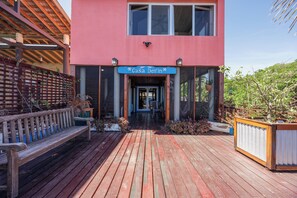 A two-story building with a sign reading 'Casa Delfin' at the entrance. - Come hang out on the dock and watch dolphins (Sandy Bay)