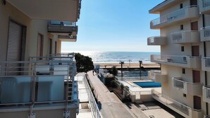 A residential building with balconies overlooking a beach. - Seaside Apartment With Balcony (Jesolo)
