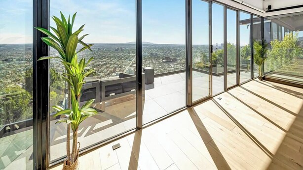A modern interior with large glass windows offering a city view. - Skyview Estate - Stylish Hollywood Hideaway With Sweeping City Views (West Hollywood)