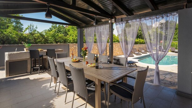 An outdoor patio with a table and chairs, a grill, and a view of a swimming pool. - Pet-friendly villa with private pool, panoramic views and free entry to the Lanterna holiday resort (Tar)