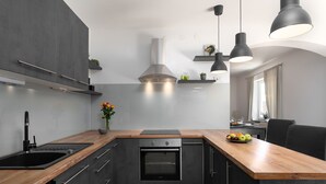 A modern kitchen with dark cabinetry, a wooden countertop, a built-in oven, and pendant lighting. - Pet-friendly villa with private pool, panoramic views and free entry to the Lanterna holiday resort (Tar)
