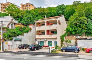 A two-story building with balconies, a sign for 'GRAWE HRVATSKA d.d.', and parked cars in front. - Romantic apartment just 500 metres from the beach with private balcony (Crikvenica)