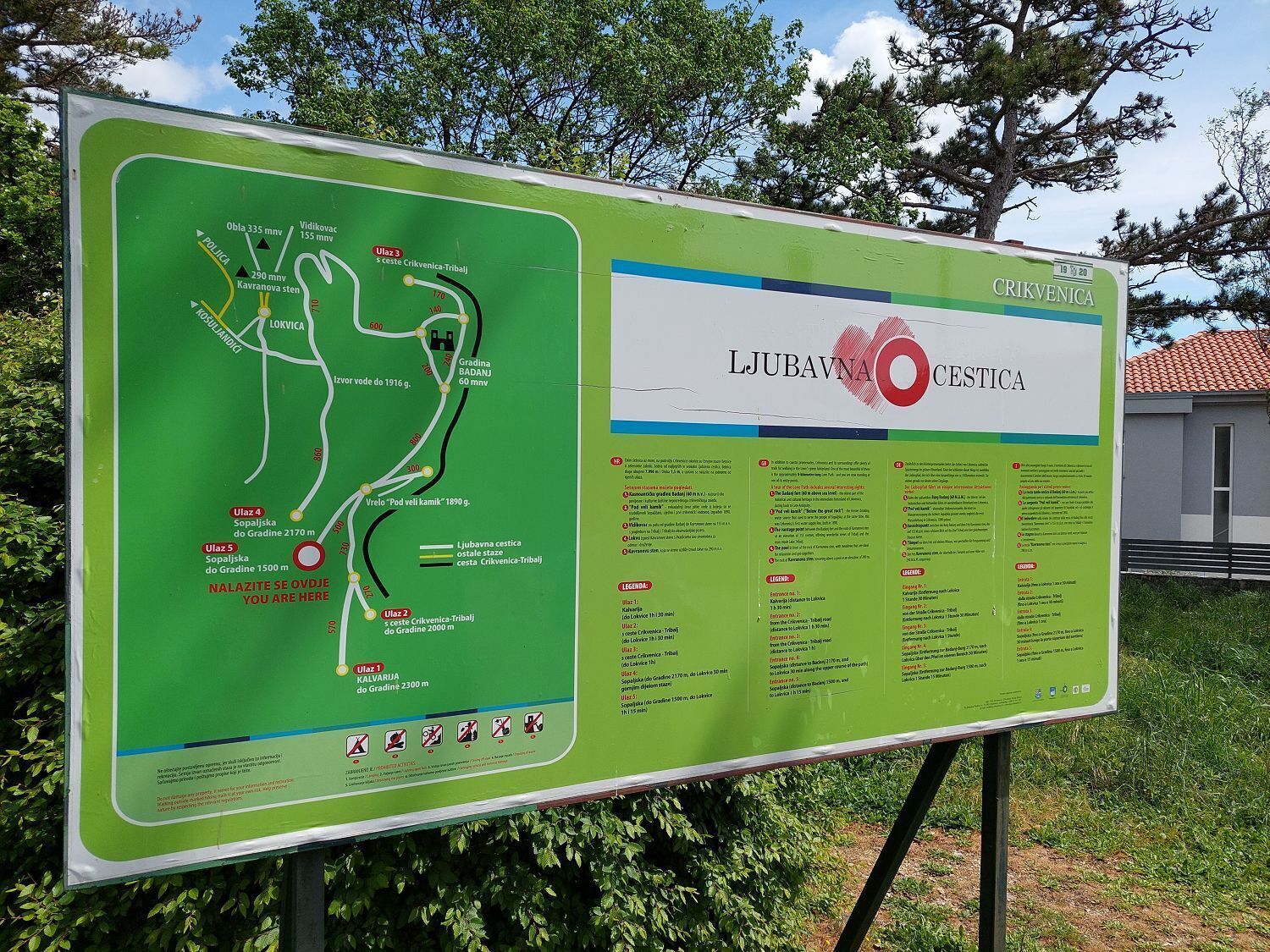 A green informational sign with a map and text about Ljubavna Ovestica.
