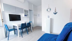 Habitació senzilla amb llit, escriptori i cadires.