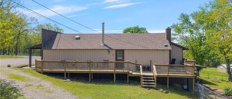 A single-story building with a covered porch and a small deck.