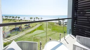 A balcony with a view of a beach and playground. - Oceanfront Serenity -V5-3E- 2 bed, 2 bath (Punta Chame)