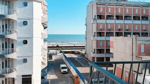 A multi-story building with balconies overlooking a beach. - Beachside Studio With Shared Pool (Jesolo)