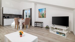 A modern apartment with a dining area, kitchen, and living room. - Stunning apartment with great sea views, washing machine, barbecue area (Crikvenica)