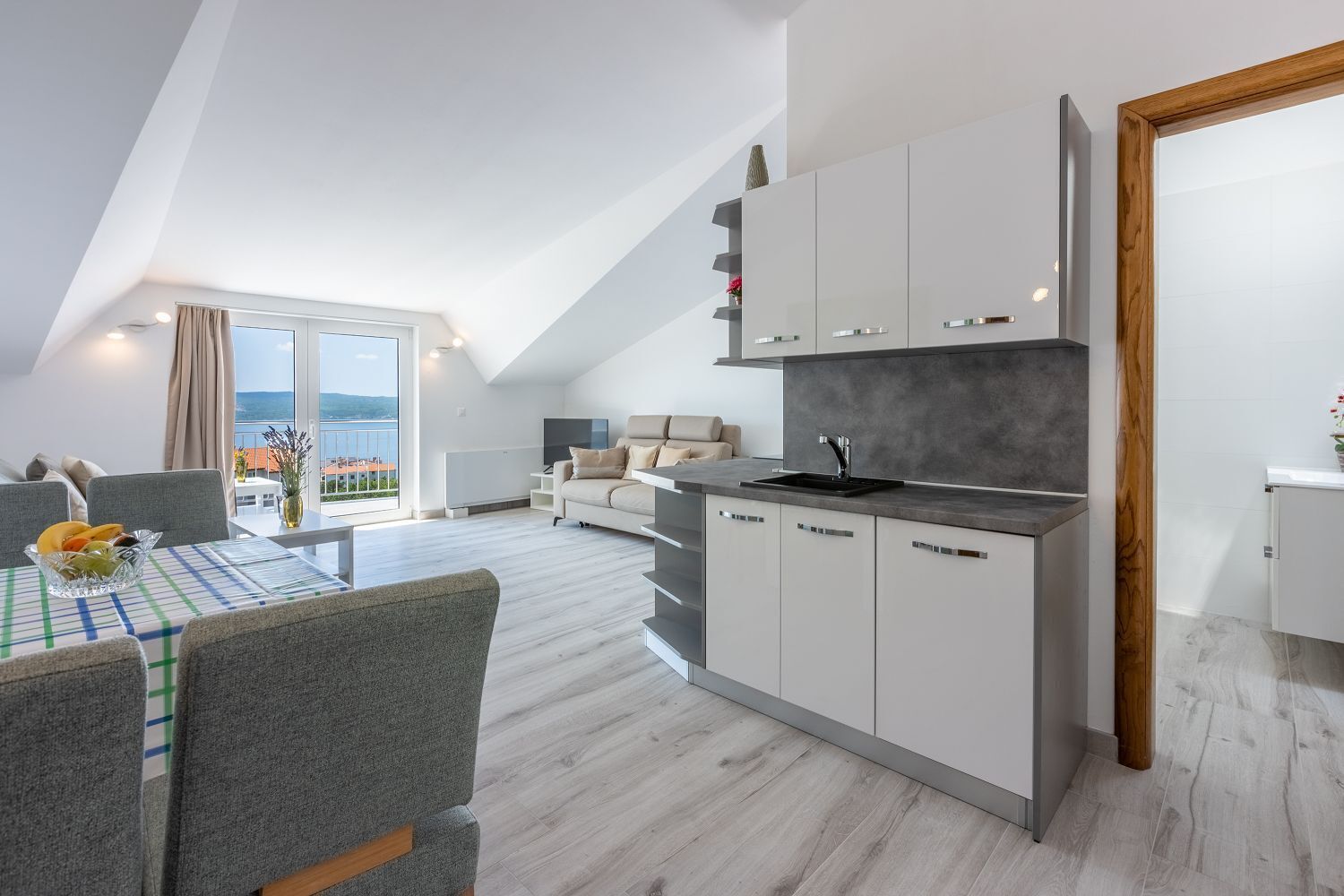 Un appartement moderne comprenant une cuisine, un coin repas et un salon.