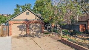 A residential garage with a brick facade and a clear driveway.