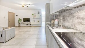 A modern kitchen with a built-in oven, a sink, and a countertop. - Central Msida | Modern, Bright & Comfortable (Msida)
