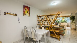 En matplats med ett bord och stolar, en stegliknande konstruktion och en tavla på väggen.