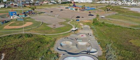 An aerial view of a park with a baseball field, skate park, and playground.