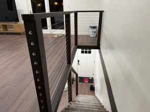 A staircase with a wooden floor and a metal railing. - Upscale Tahoe Monthly - 10 Min Walk to Beach - Pet Friendly (Kings Beach)