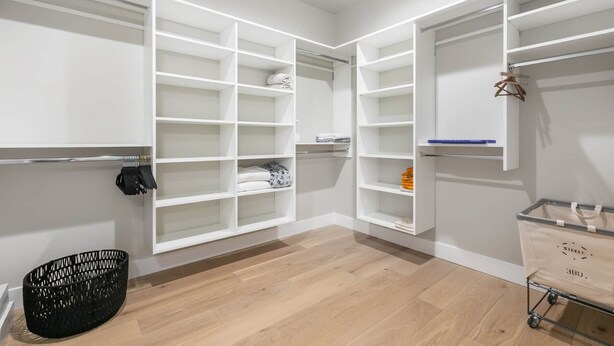 A walk-in closet with open shelving, a hanging rod, and a storage cart. - 4BR Deer Valley East | Hot Tub | Shuttle + Views (Wasatch County)