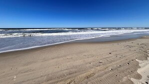 A beach with a clear sky and waves. - 8Min Walk2Beach,Hot tub, GameRM, Family (Corolla)