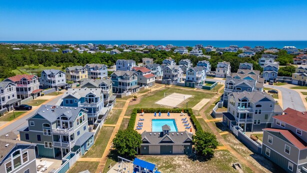 A residential area with multiple two-story houses, a swimming pool, and a view of the ocean. - 8Min Walk2Beach,Hot tub, GameRM, Family (Corolla)