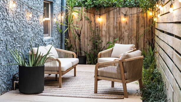 A cozy outdoor seating area with wicker chairs and a potted plant. - Little Havana Cabana – Retro Surf-Lodge Hideaway (Miami)
