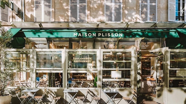 A storefront with a green awning labeled "MAISON PLISSON" and "BOULANGERIE RESTAURANT" with outdoor seating. - PARISIAN LIVING IN LE MARAIS: SPACIOUS FAMILY APARTMENT WITH GARDEN VIEW - 3 BED (Paris)