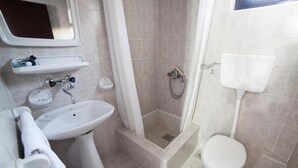 A bathroom with a sink, toilet, shower, and a mirror above the sink. - Guest House 4M Gregović - Triple bed Studio 4 (Petrovac na Moru)