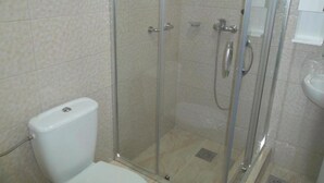 A bathroom with a glass-enclosed shower, a toilet, and a sink. - Guest House 4M Gregović - Triple bed Studio 4 (Petrovac na Moru)