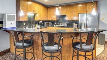 Fridge, microwave, coffee/tea maker, cookware/dishes/utensils