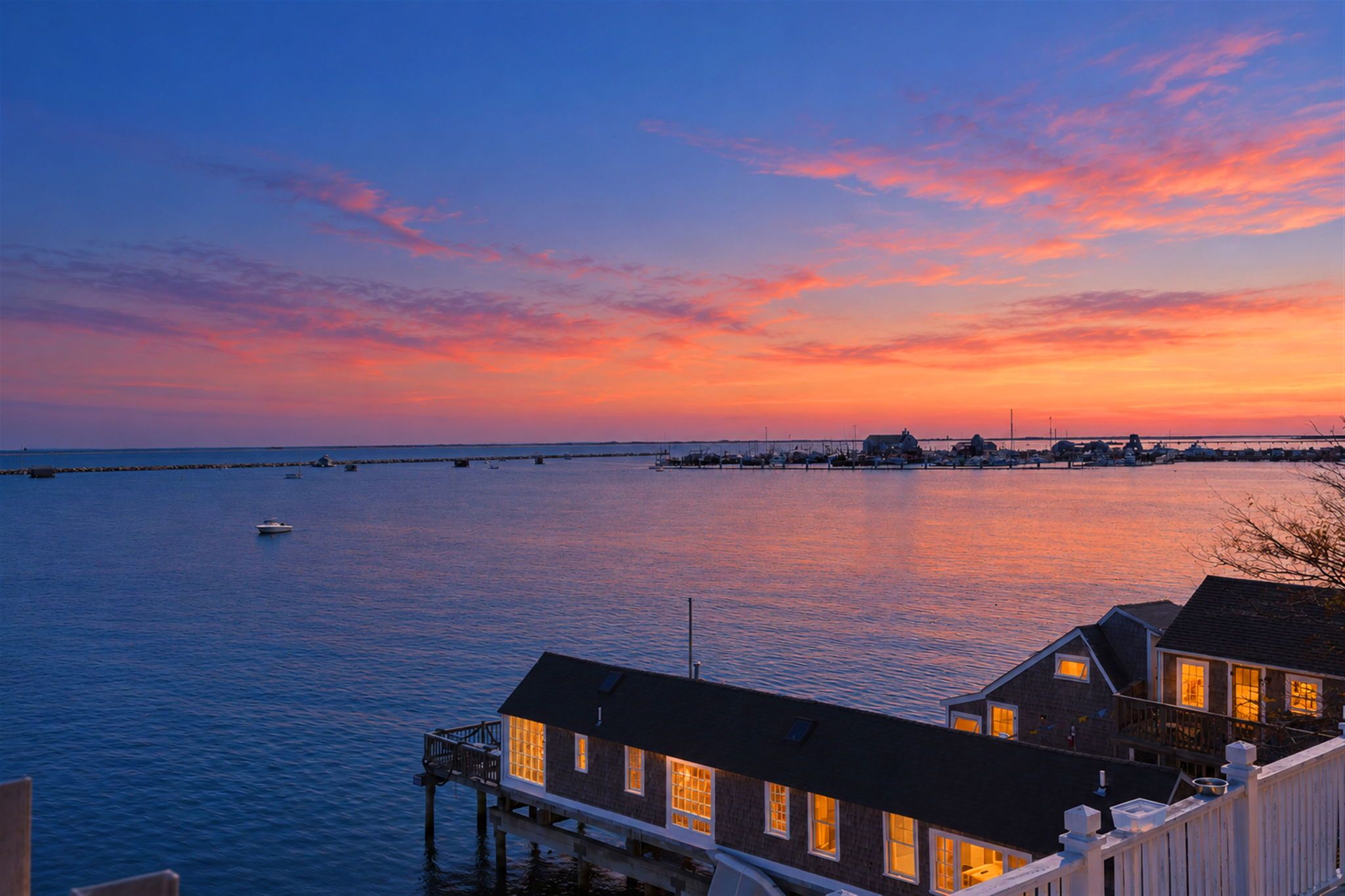 A waterfront property with a dock, a pier, and a view of the water.