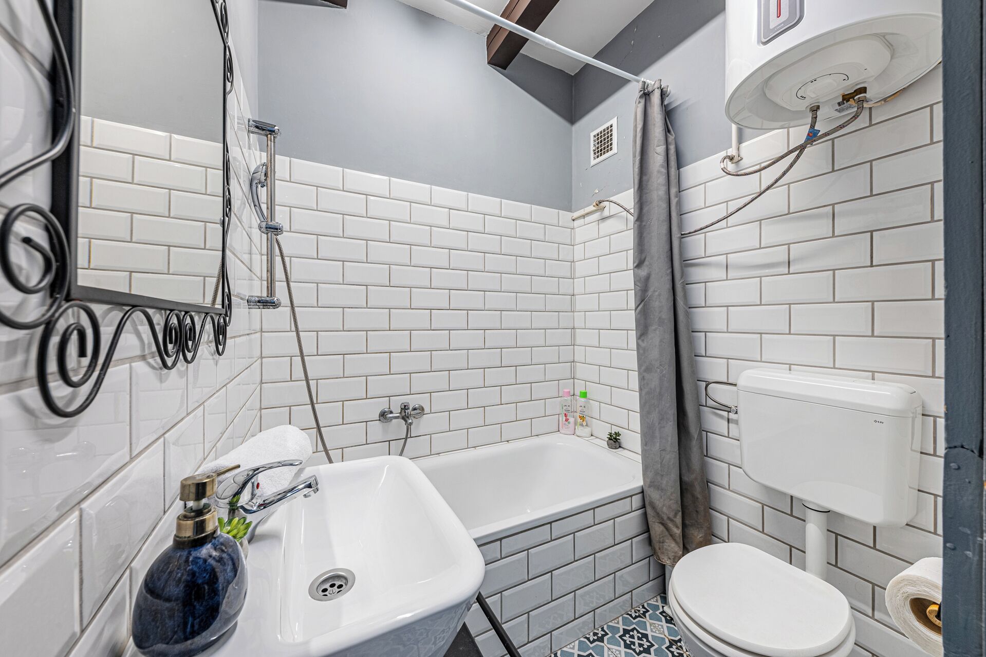 A bathroom with a bathtub, sink, toilet, and shower.