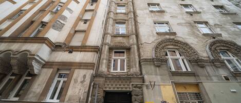 A multi-story building with classical architectural features, including columns, arched windows, and decorative moldings.