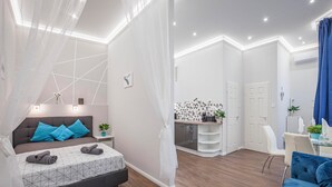 A modern bedroom with a bed, bedside table, and a nightstand. - Quiet Downtown Haven— 2Br | A/C | Free Parking (Budapest)