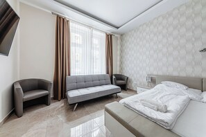 Apartamento, 2 habitaciones | Zona de estar | Una televisión de pantalla plana