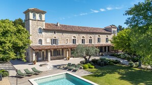 A stone building with a swimming pool, outdoor seating, and a garden. - L'Angélus Mas in Provence for 14 people • Heated swimming pool - Families & groups (Noves)