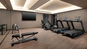 A modern gym with treadmills, weight machines, and a bench press. - Days Inn By Wyndham Zhengzhou Xinzheng Airport (Zhengzhou)