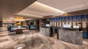 A modern hotel lobby with marble flooring, a reception desk, a dining area, and a large chandelier. - Days Inn By Wyndham Zhengzhou Xinzheng Airport (Zhengzhou)