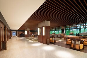 A spacious lobby with a grand piano, seating areas, and a coffee bar. - Ramada Encore By Wyndham Shantou Longhu (Shantou)