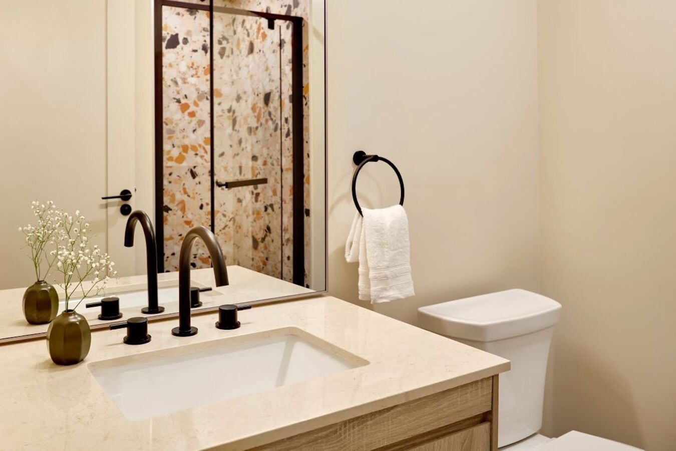 A bathroom with a sink, mirror, and toilet.