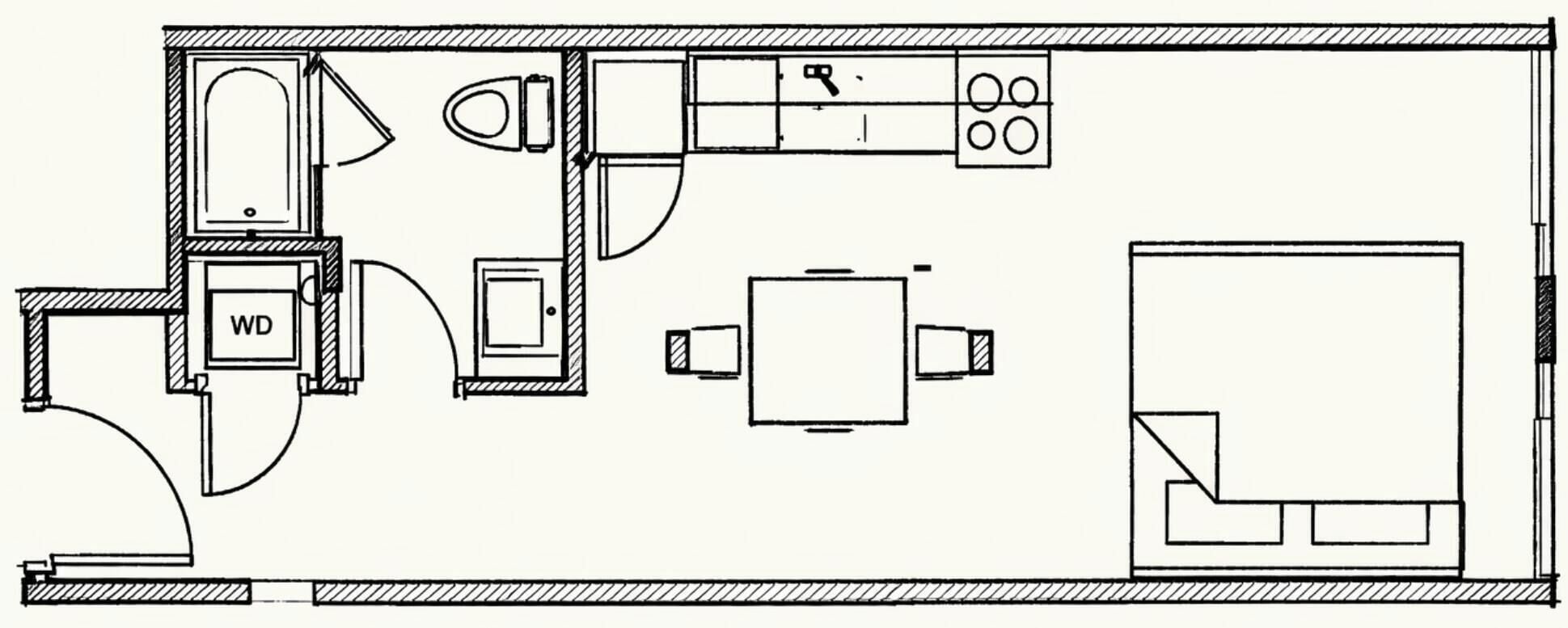 A floor plan of a hotel room with a WC, a bed, a small table, and a chair.