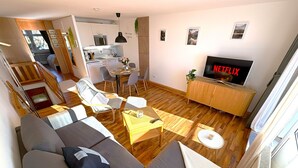Una sala de estar moderna con un sofá, una mesa de centro y un televisor que muestra Netflix.