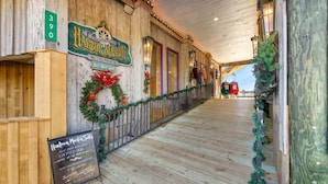 A wooden interior with a sign for 'Harbor Master Shopspees' and a signboard for 'Harbor Master' with a URL. - Corrigan`s Reef at Harbour Master Suites (Cedar Key)