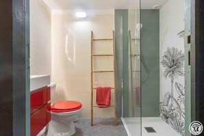 Ein Badezimmer mit Toilette, Dusche und einer Leiter.