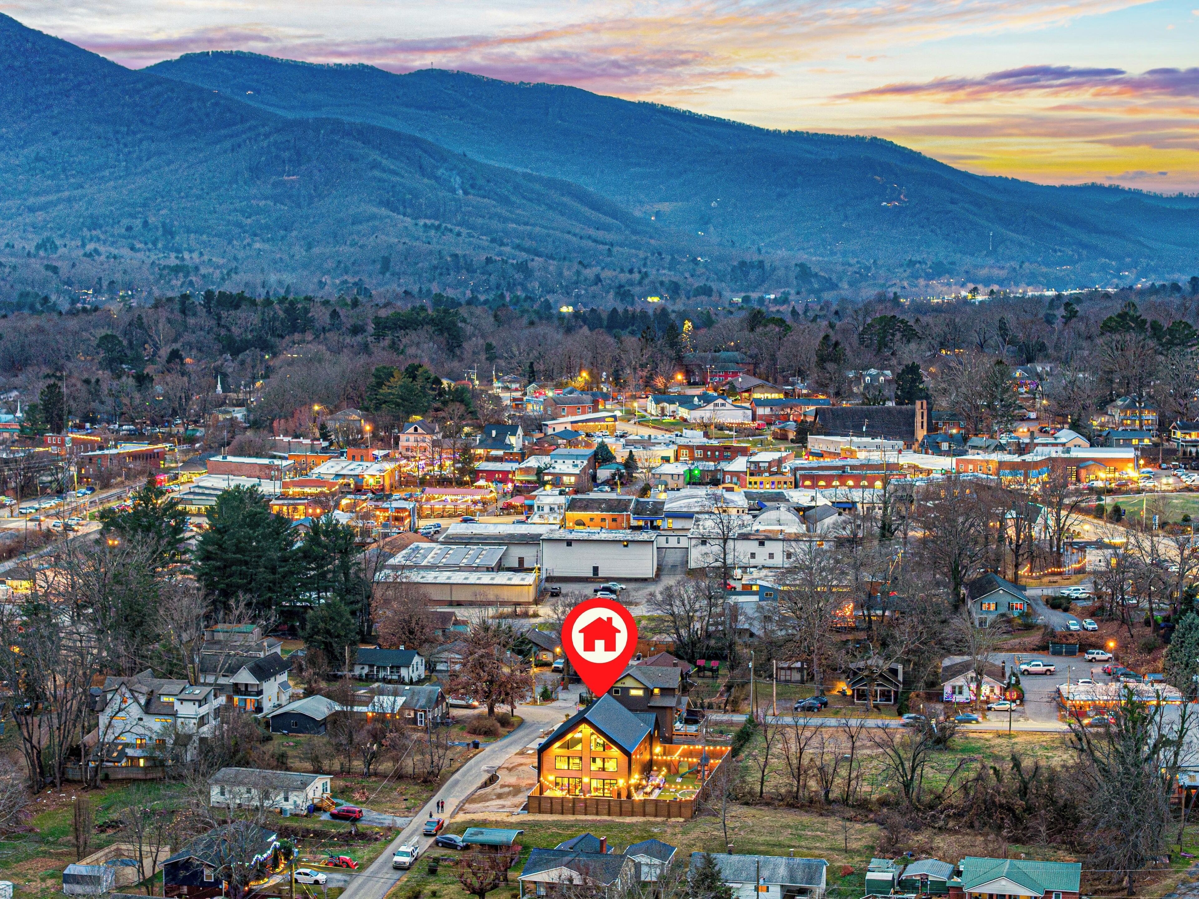 A town with a prominent red sign indicating a location.